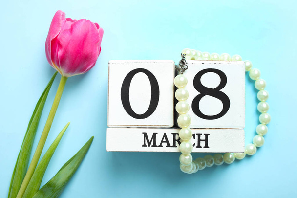 schöne rosa Tulpen und Kalender auf blauem Hintergrund. Konzept Internationaler Frauentag, 8. März. - Foto, Bild