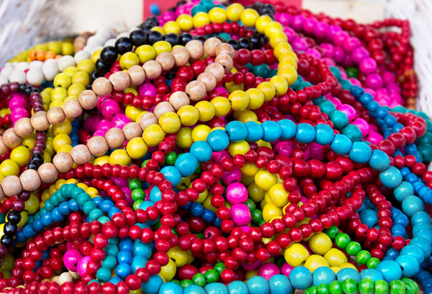 Ethnic wooden multicolored necklaces at market, traditional decorations - Photo, Image