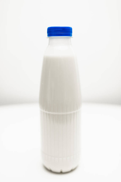 milk bottles on white table - Фото, изображение