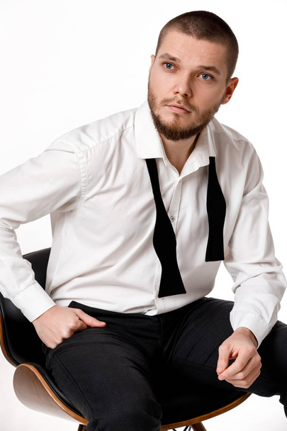 portrait of young bearded man in white shirt and untied bow tie - Foto, immagini