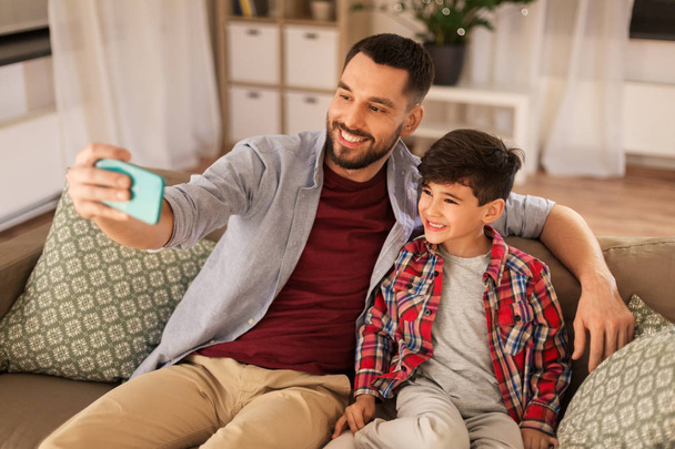 father and son taking selfie at home - Photo, Image