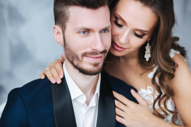 Wedding couple hugging each other indoor.Close-up portrait of wedding couple . Beauty bride with groom. - Photo, image
