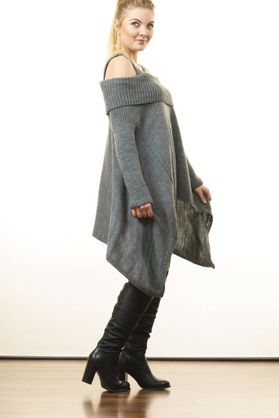 Woman in ponytail wearing gray long top sweater tunic, black tights. Stylish, autumnal outfit. - Foto, immagini