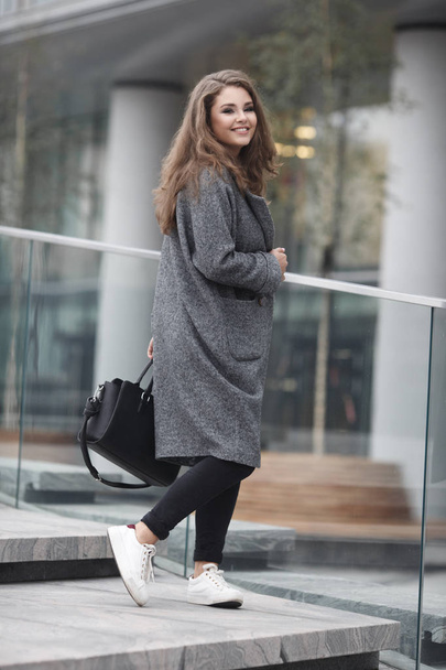 Portrait of beautiful young woman in gray coat outdoors - Fotografie, Obrázek