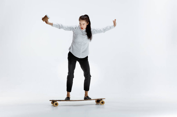 businesswoman riding skate on white background - Fotoğraf, Görsel