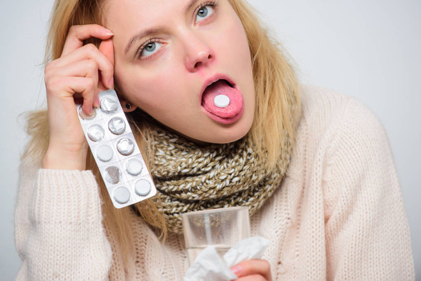 Headache and fever remedies. Woman sick person hold glass water and tablets blister. Take pills relieve fever. Drink plenty of fluids. Breaking fever concept. Girl take medicine to break fever - Photo, Image