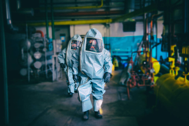 Rescuers in a radiation protection suit. - Photo, Image
