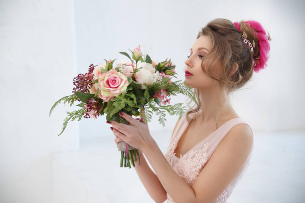 Portrait of elegant bride in wedding dress holding bouquet  - Fotó, kép