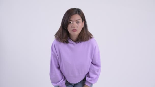 Young beautiful Asian woman looking shocked - Filmagem, Vídeo