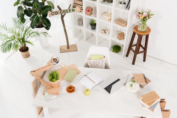 overhead view of workspace near go green sign in modern office, environmental saving concept  - 写真・画像