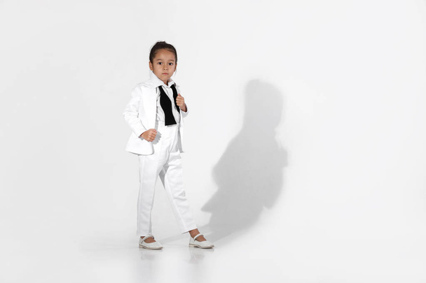 fashion little girl model in a white suit and bow tie - Zdjęcie, obraz