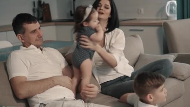 Happy family sitting on couch at home - Filmmaterial, Video