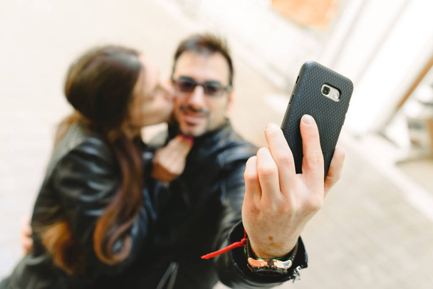 Couple in love doing a self-portrait selfie with the mobile phone. - Photo, image