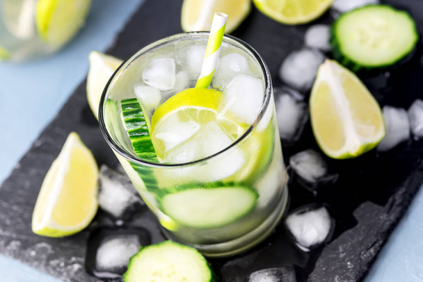 Cold and Refreshing Infused Detox Water with Lime and Cucumber in a Glass With Ice Cube Healthy Detox Drink Above - Fotoğraf, Görsel