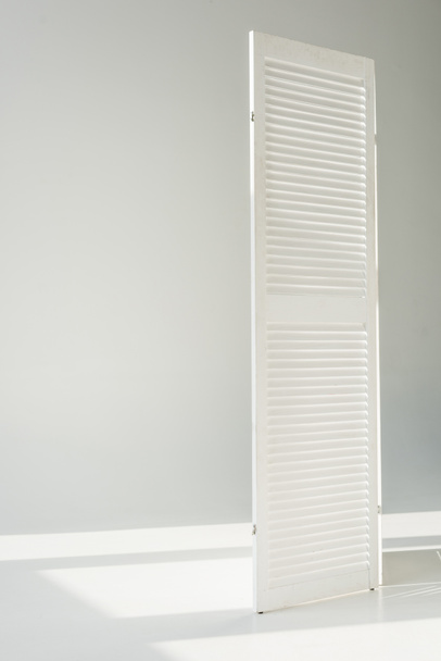 white textured door standing on grey background - Photo, Image