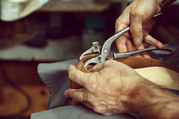 Enjoying process of creation custom made shoes. Workplace of shoe designer - Fotografie, Obrázek