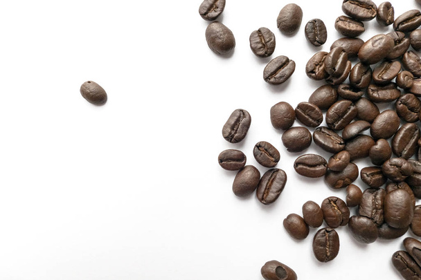 Roasted coffee beans isolated on white background. Close-up image. - Фото, изображение