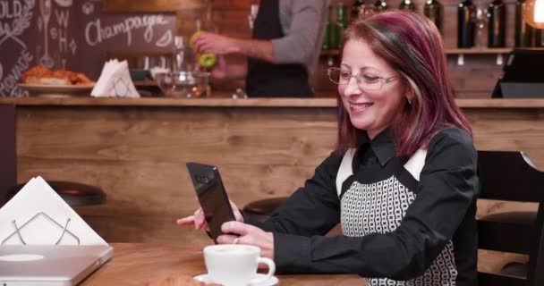 Video call on smartphone in vintage and styled coffee shop - Footage, Video