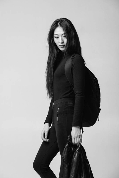 asian model in black jacket posing in studio - 写真・画像