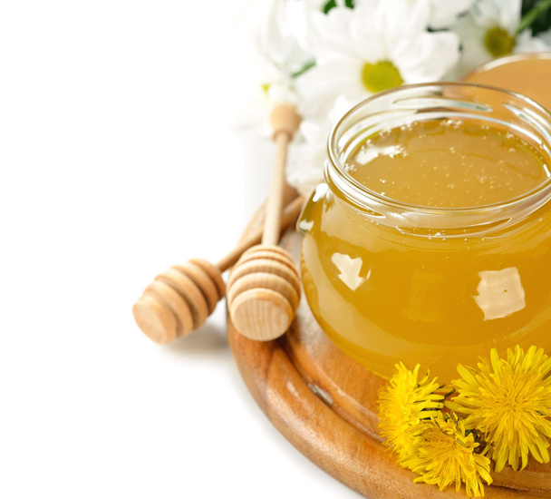 Honey and flowers on a white background - Foto, Imagen