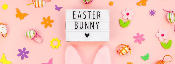 Creative Top view flat lay holiday composition Easter bunny text on lightbox pink paper background copy space Template Easter day seasonal pattern - Foto, afbeelding