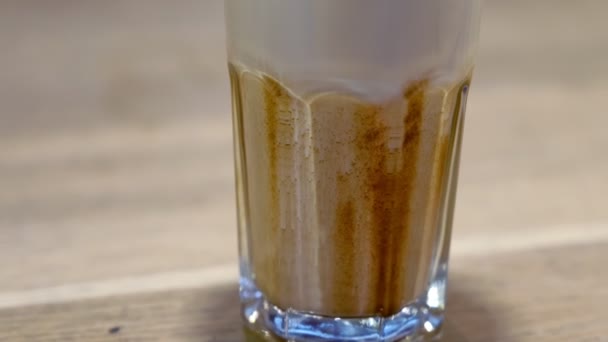 Milk with chocolate topping in glass for coffee. - 映像、動画