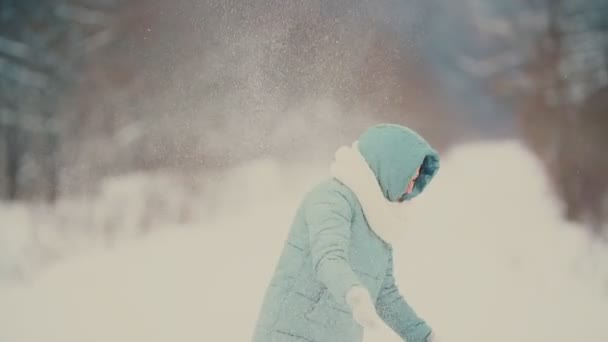 beautiful girl throws snow - Materiał filmowy, wideo