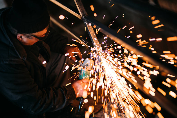 construction engineer using a circular saw cutting steel and iron - Foto, Bild
