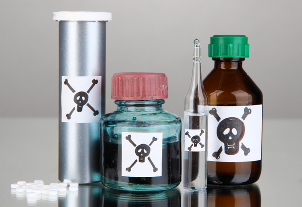 Deadly poison in bottles on grey background - Foto, afbeelding