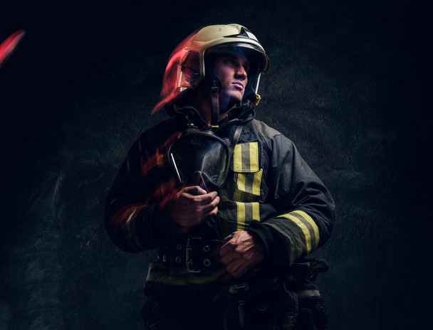 Mužný hasič v helmě vypadá bokem - Fotografie, Obrázek