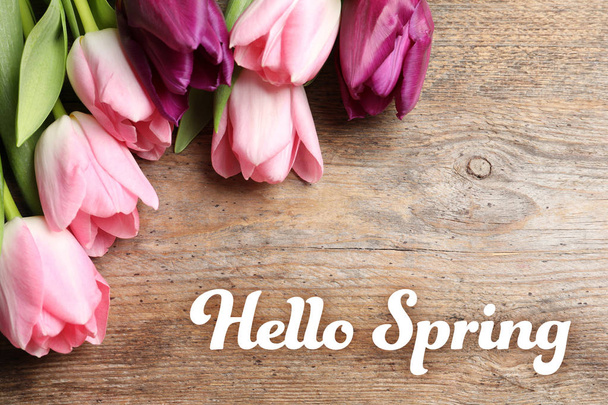 Beautiful flowers and text Hello Spring on wooden background - Foto, immagini