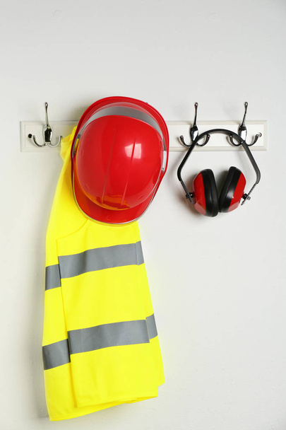 Different safety equipment hanging on white wall - 写真・画像