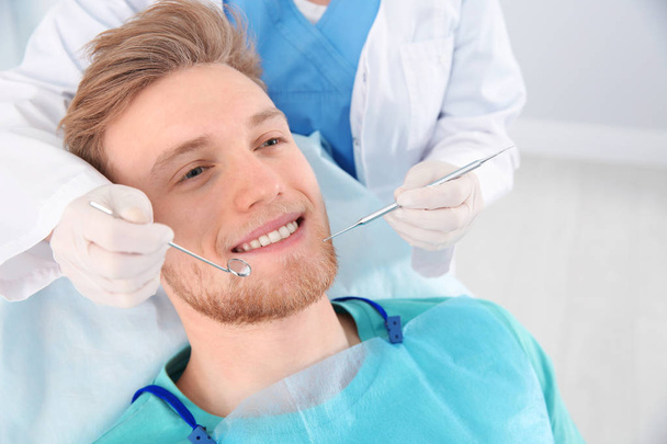 Dentist examining patient's teeth in modern clinic - Foto, Imagem