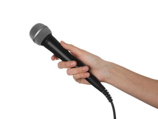 Woman holding dynamic microphone on white background, closeup - Photo, image