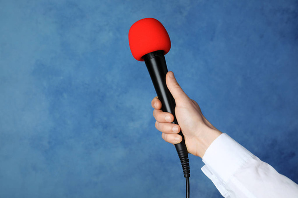 Woman holding microphone on color background, space for text - Fotoğraf, Görsel