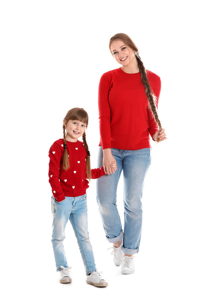 Happy woman and daughter in stylish clothes on white background - 写真・画像
