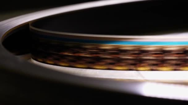 Κοντινό πλάνο του μια συγκινητική λωρίδα φιλμ 35mm σε μια ταινία θέατρο - Πλάνα, βίντεο