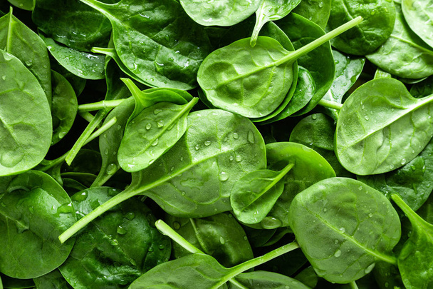 Fresh spinach leaves background. Healthy vegan food. Top view - Foto, afbeelding