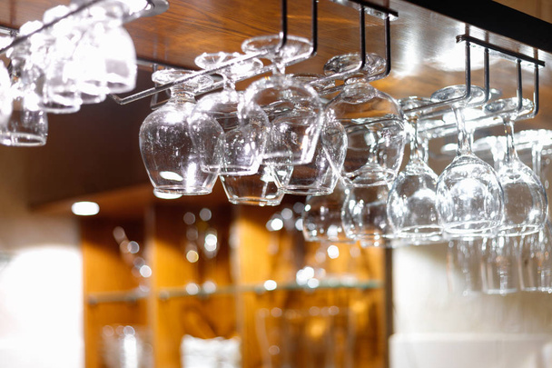 Empty  glasses hanging above the bar in the restaurant. Night life  - Foto, Imagem