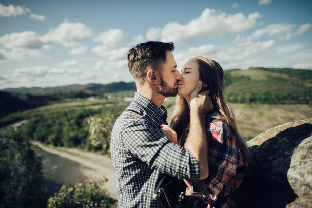 Portrait of happy young couple in mountain landscape  - 写真・画像