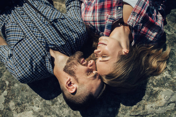 portrait of young hipster couple lying on mountain rock  - Foto, immagini