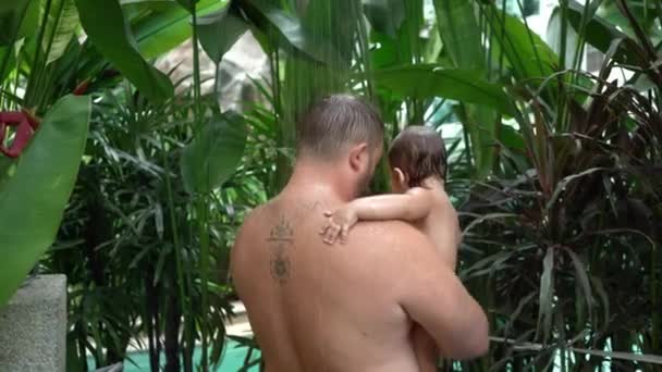 papà e figlia sotto una doccia a pioggia sullo sfondo di verde
 - Filmati, video