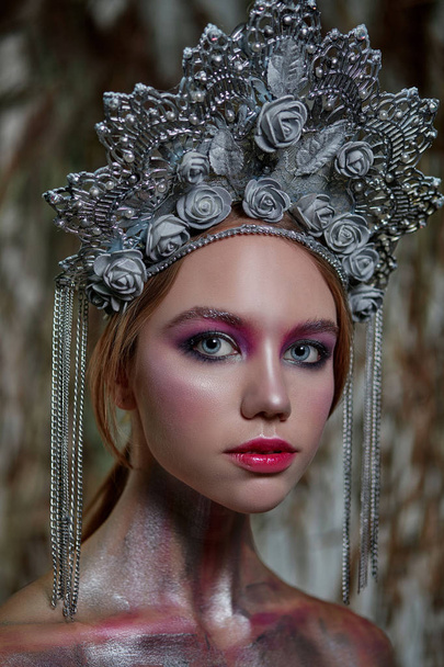 girl in silver makeup and red lips in silver headdress on nature background - Foto, Bild