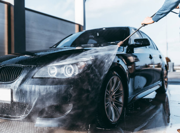 Car washing. Cleaning car using high pressure water.  - Fotoğraf, Görsel