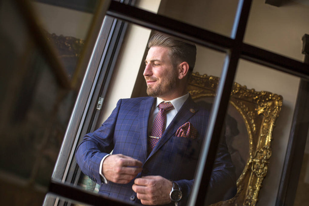 Handsome man posing when he watch on window in luxury hotel room - Fotoğraf, Görsel