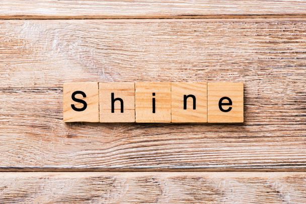 Shine word written on wood block. Shine text on wooden table for your desing, concept. - Zdjęcie, obraz