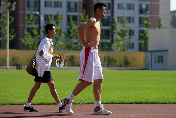Chinese basketball superstar Yao Ming, right, and Guo Shiqiang, assistant coach of Chinese national men basketball team during a training session in Beijing 29 August 2007 after Yao Ming and his wife Ye Li spent their honeymoon in Europe. - Photo, image