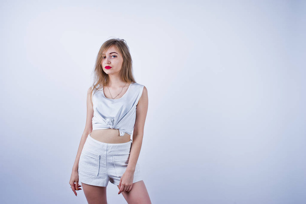 Incrível ajuste sexy corpo morena caucasiano menina posando no estúdio contra fundo branco em shorts e top
. - Foto, Imagem