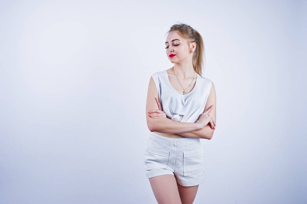 Amazing fit sexy body brunette caucasian girl posing at studio against white background on shorts and top. - Valokuva, kuva