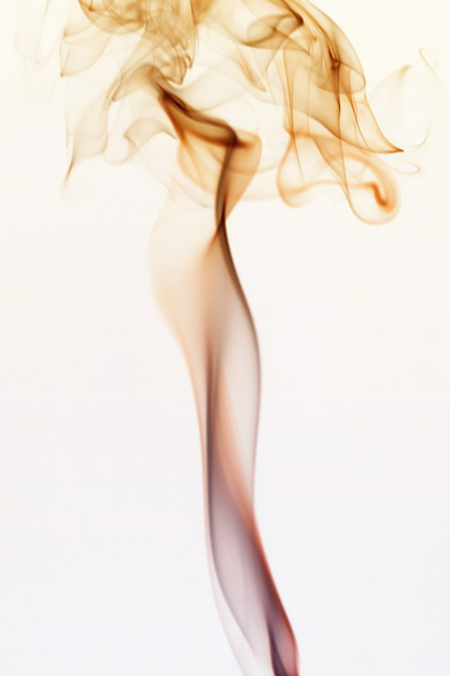 Swirling smoke from the incense on a homogeneous background - Photo, Image
